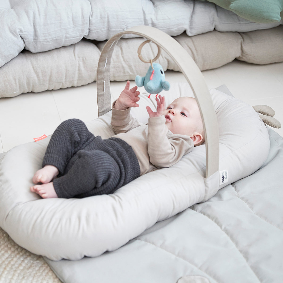 Baby using a Done by Deer cozy lounger